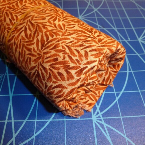 Fabric with abstract natural pattern in shades of orange, brown, and beige - Picture 2 of 3